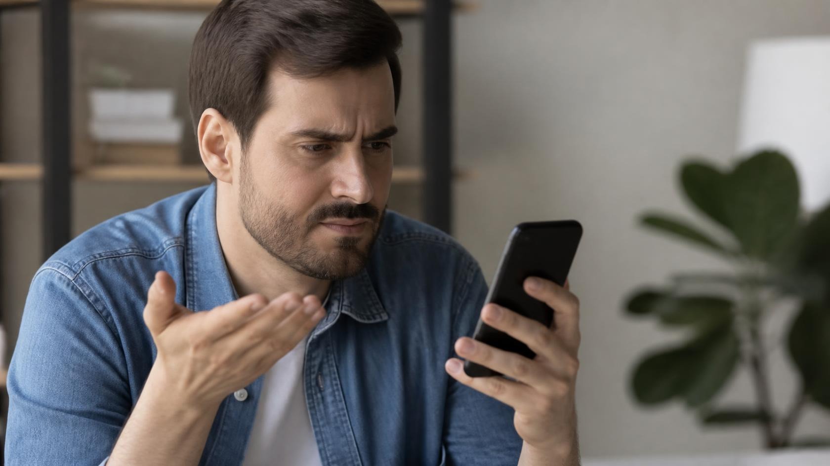 Frustrated person pressing phone keypad IVR menu
