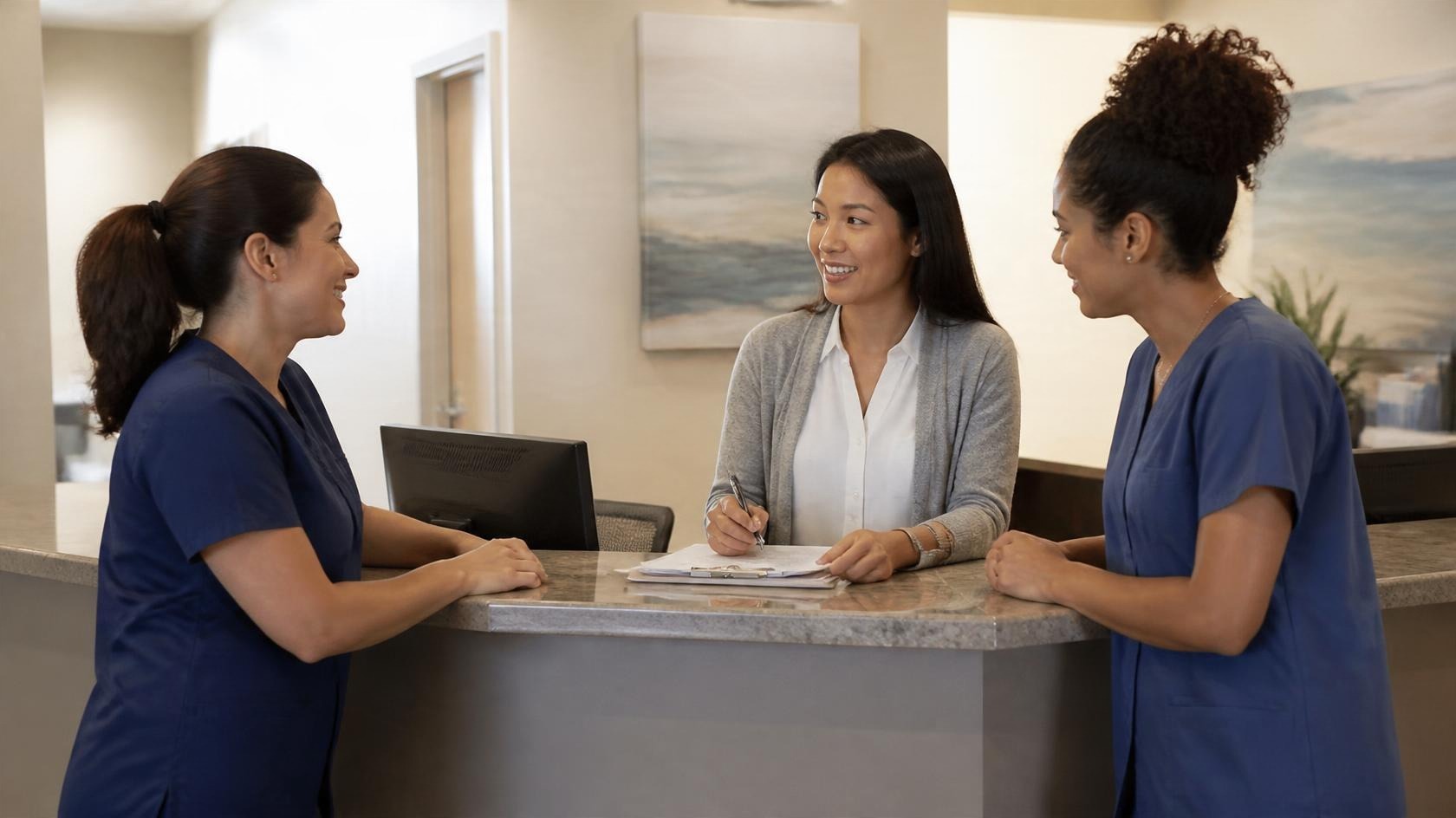 Medical front desk team planning together at the reception counter Medical front desk team planning together at the reception counter